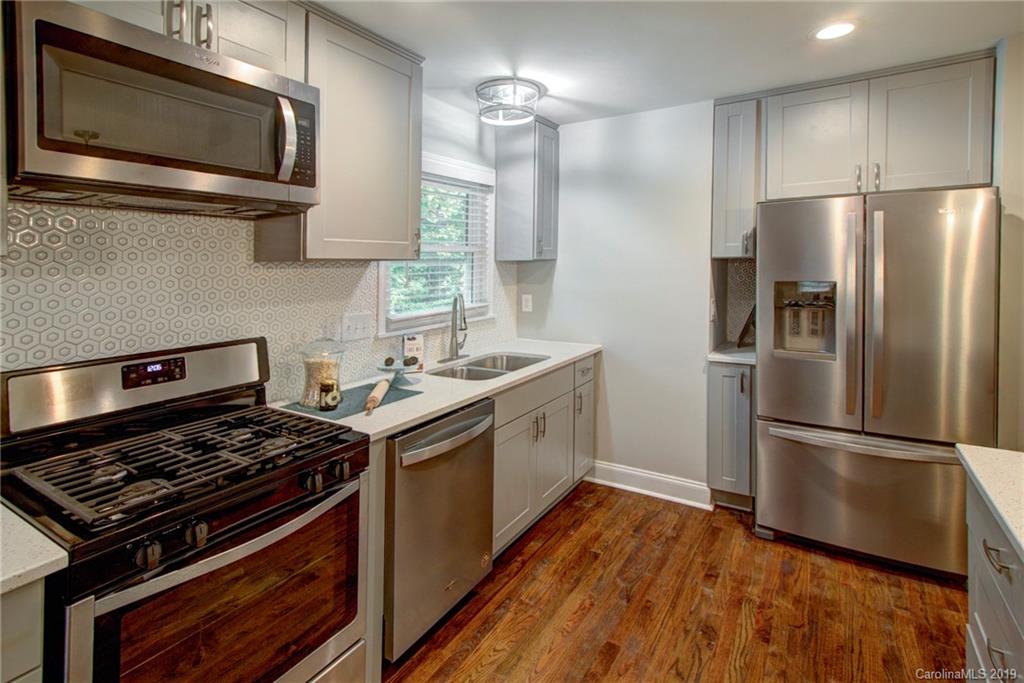 7439 Watercrest Road Charlotte, NC 28210 - Photo 11 of 28 a kitchen with a stove microwave and refrigerator