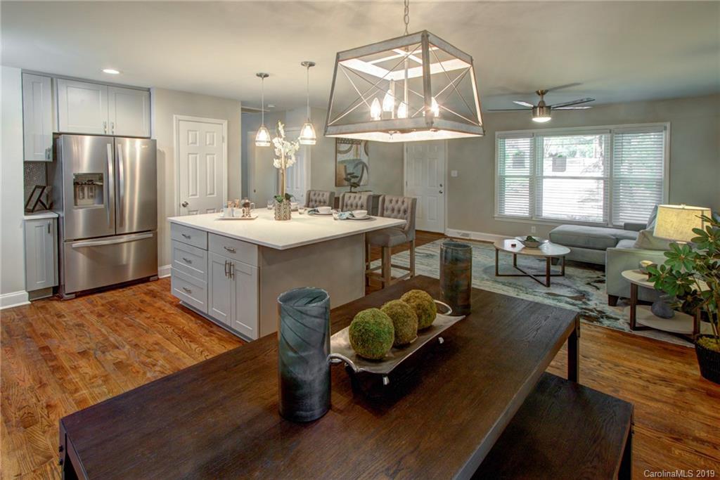 7439 Watercrest Road Charlotte, NC 28210 - Photo 12 of 28 a kitchen with stainless steel appliances kitchen island hardwood floor and breakfast area
