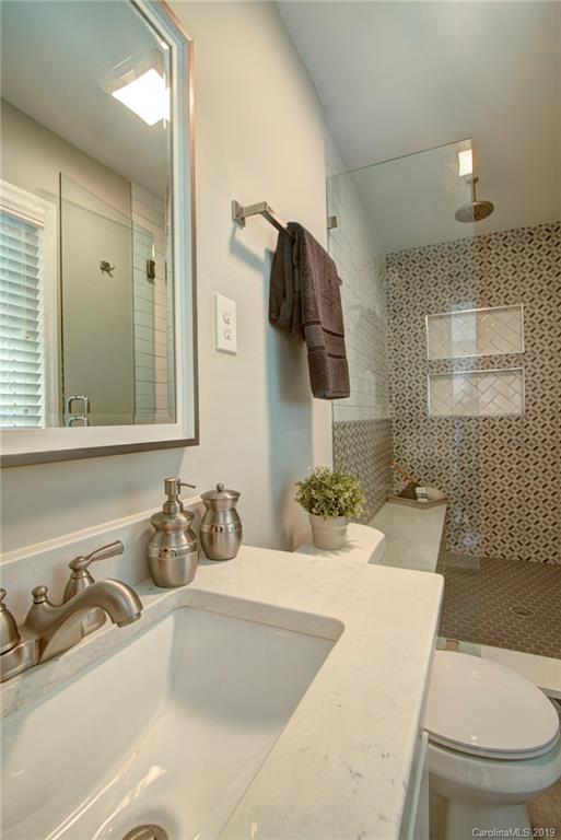7439 Watercrest Road Charlotte, NC 28210 - Photo 15 of 28 a bathroom with a sink a toilet and mirror
