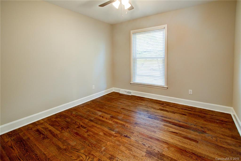 7439 Watercrest Road Charlotte, NC 28210 - Photo 18 of 28 an empty room with wooden floor and windows