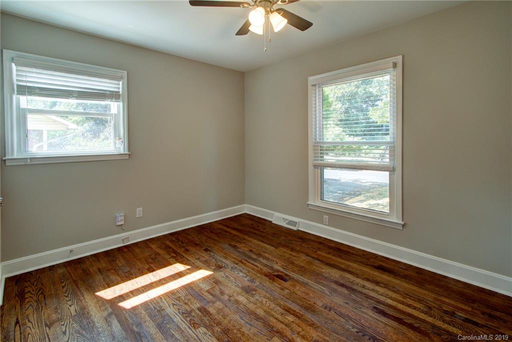 7439 Watercrest Road Charlotte, NC 28210 - Photo 19 of 28 a view of an empty room with wooden floor and a window