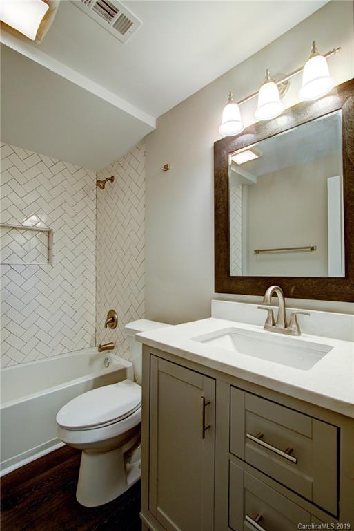 7439 Watercrest Road Charlotte, NC 28210 - Photo 20 of 28 a bathroom with a toilet sink and mirror
