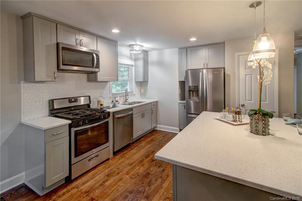 7439 Watercrest Road Charlotte, NC 28210 - Photo 5 of 28 a kitchen with stainless steel appliances a stove a sink and a refrigerator