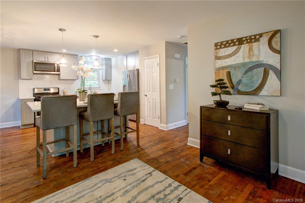7439 Watercrest Road Charlotte, NC 28210 - Photo 10 of 28 a view of a dining room with furniture and wooden floor