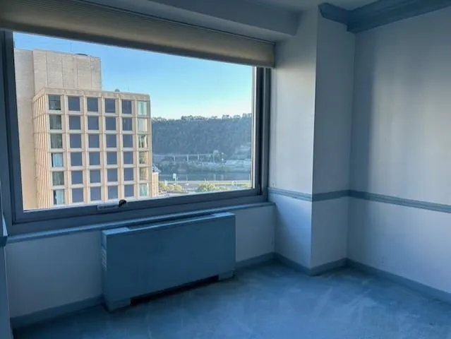 a picture of a living room with a floor to ceiling window and floor to ceiling window