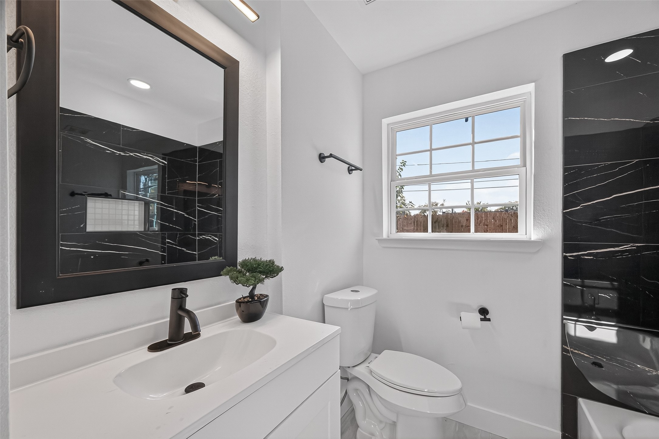 3112 Hays Street Pasadena, TX 77503 - Photo 17 of 22 a bathroom with a sink toilet a mirror and shower