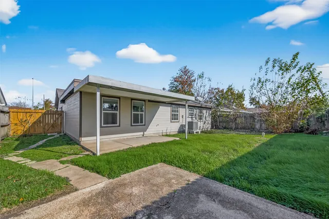 a view of a house with a yard and a garden