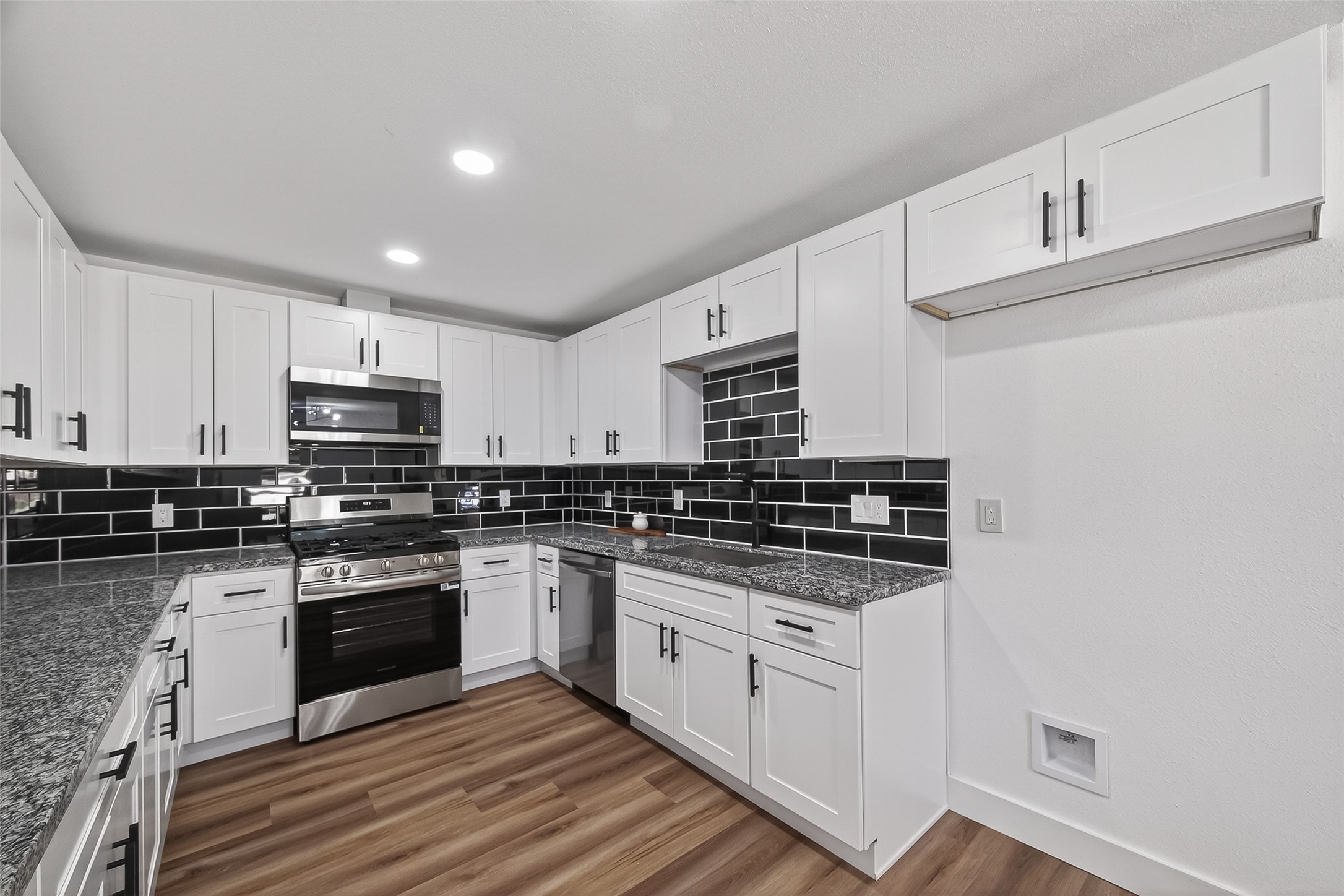 3112 Hays Street Pasadena, TX 77503 - Photo 2 of 22 a kitchen with stainless steel appliances granite countertop a stove and a sink