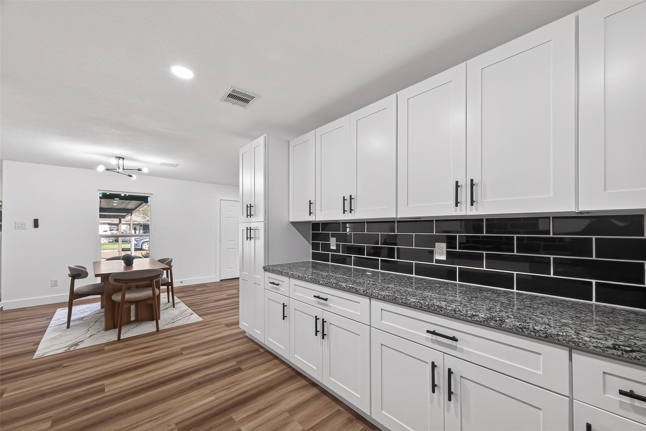 3112 Hays Street Pasadena, TX 77503 - Photo 4 of 22 a kitchen with granite countertop a sink a stove and cabinets