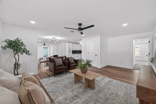 a living room with furniture and a potted plant