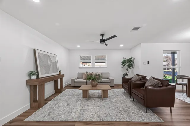 a living room with furniture and wooden floor
