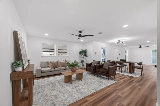 a living room with furniture and wooden floor