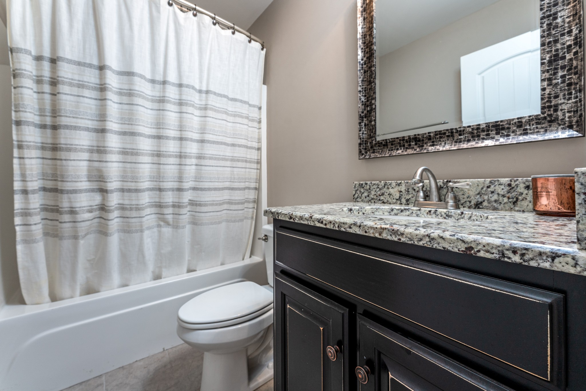 1061 Irish Way Spring Hill, TN 37174 - Photo 20 of 26 a bathroom with a granite countertop sink toilet and shower