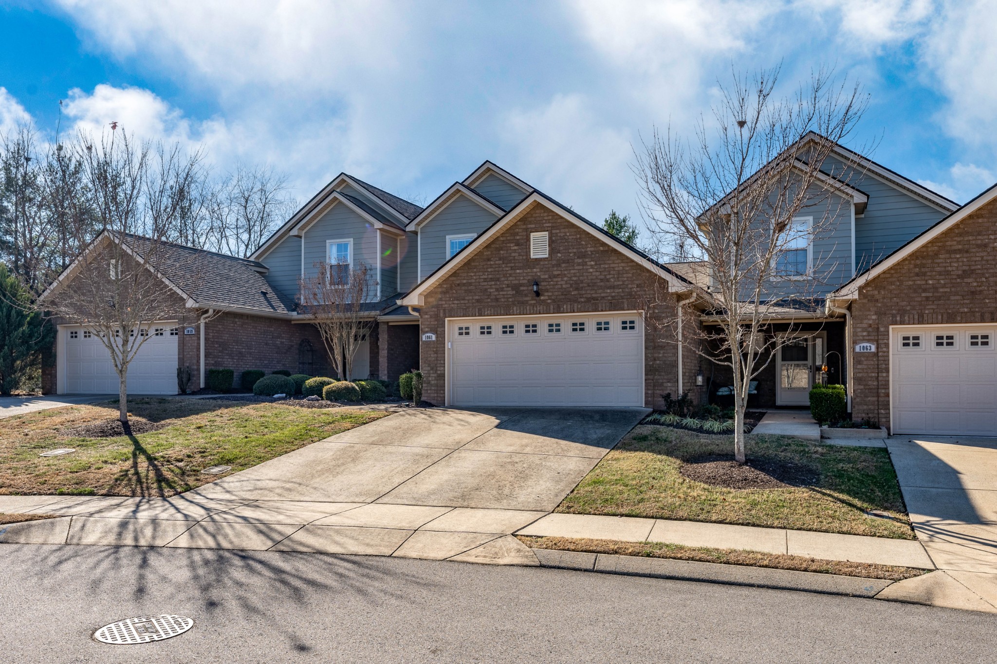1061 Irish Way Spring Hill, TN 37174 - Photo 2 of 26 a front view of a house with a yard and garage