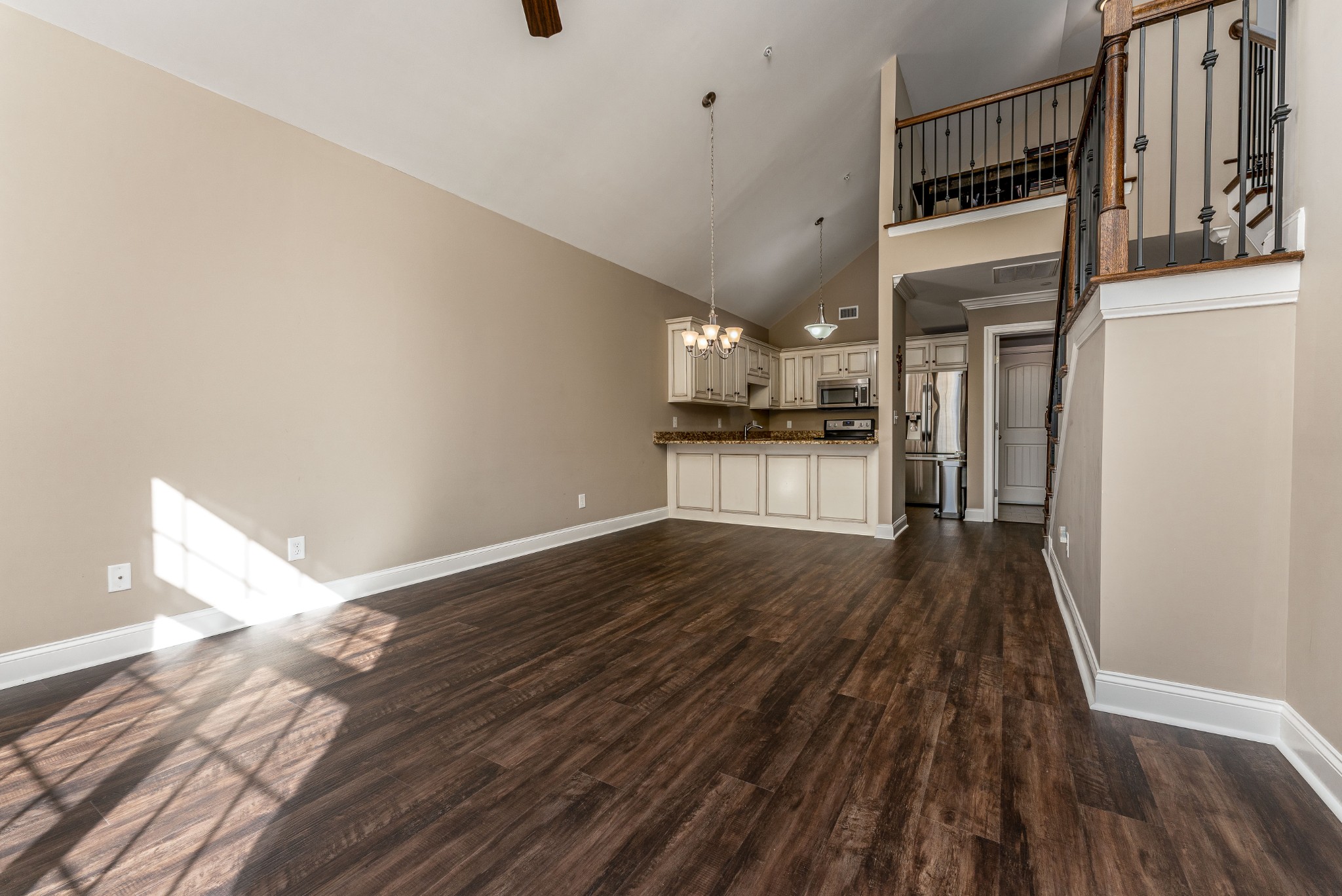 1061 Irish Way Spring Hill, TN 37174 - Photo 6 of 26 a view of a kitchen with wooden floor and a ceiling fan
