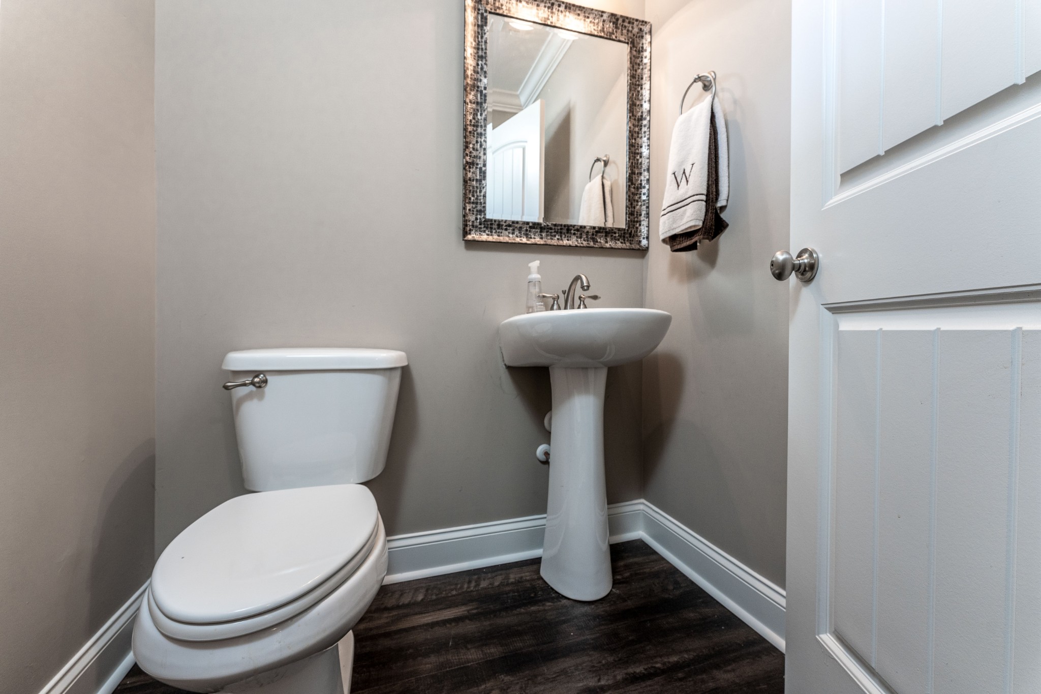 1061 Irish Way Spring Hill, TN 37174 - Photo 10 of 26 a white toilet sitting next to a bathroom sink