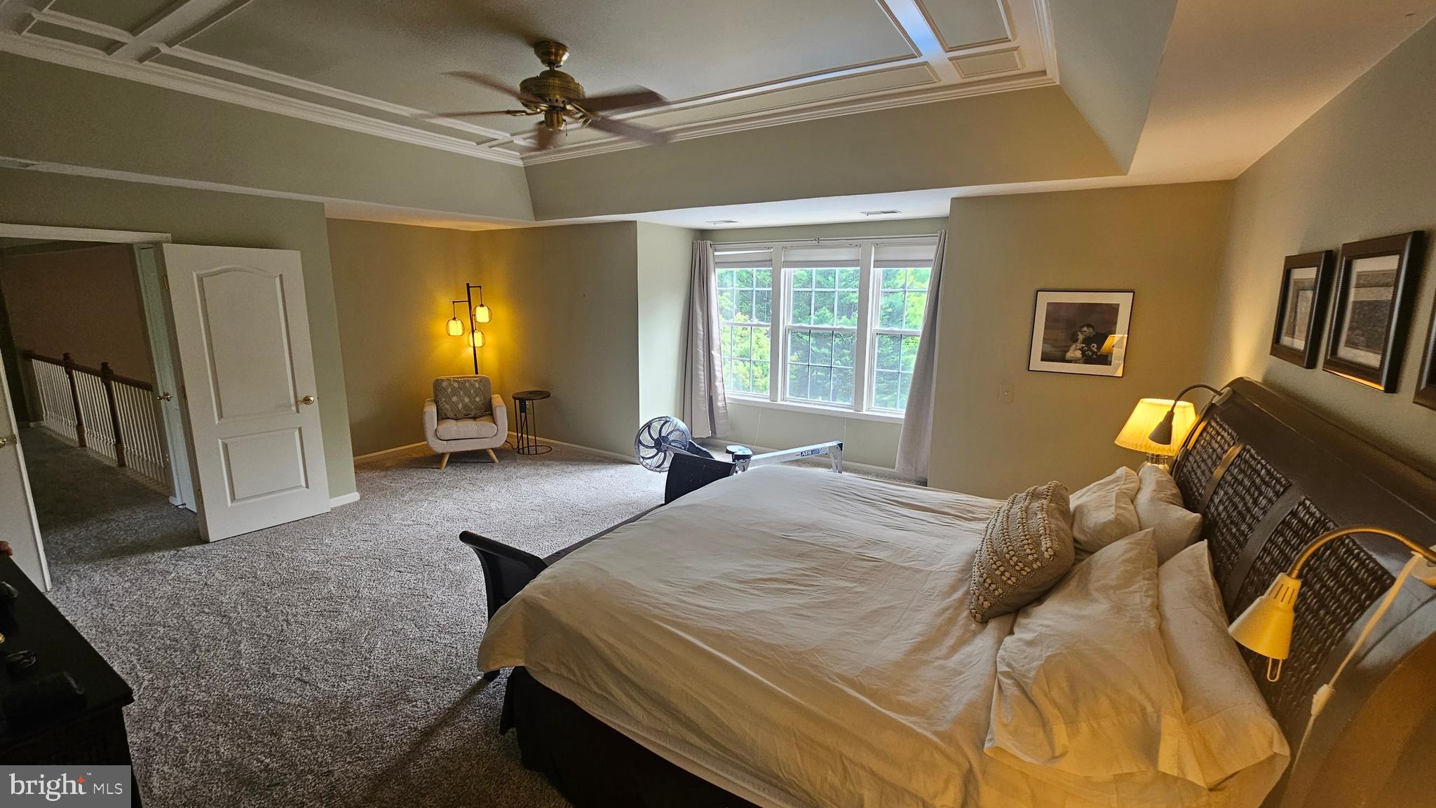 6107 Traceys Overlook Road Tracys Landing, MD 20779 - Photo 26 of 67 a spacious bedroom with a bed a couch and a chandelier