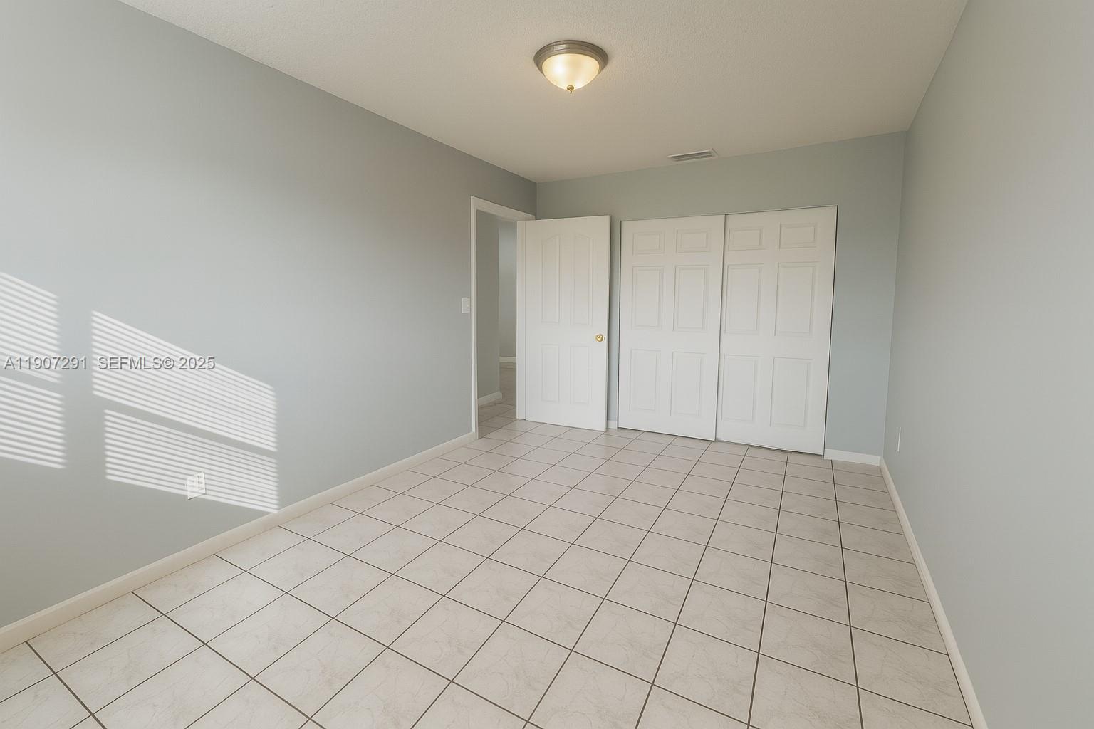 18250 Mediterranean Boulevard, Unit 1508 Hialeah, FL 33015 - Photo 15 of 26 a view of an empty room and window
