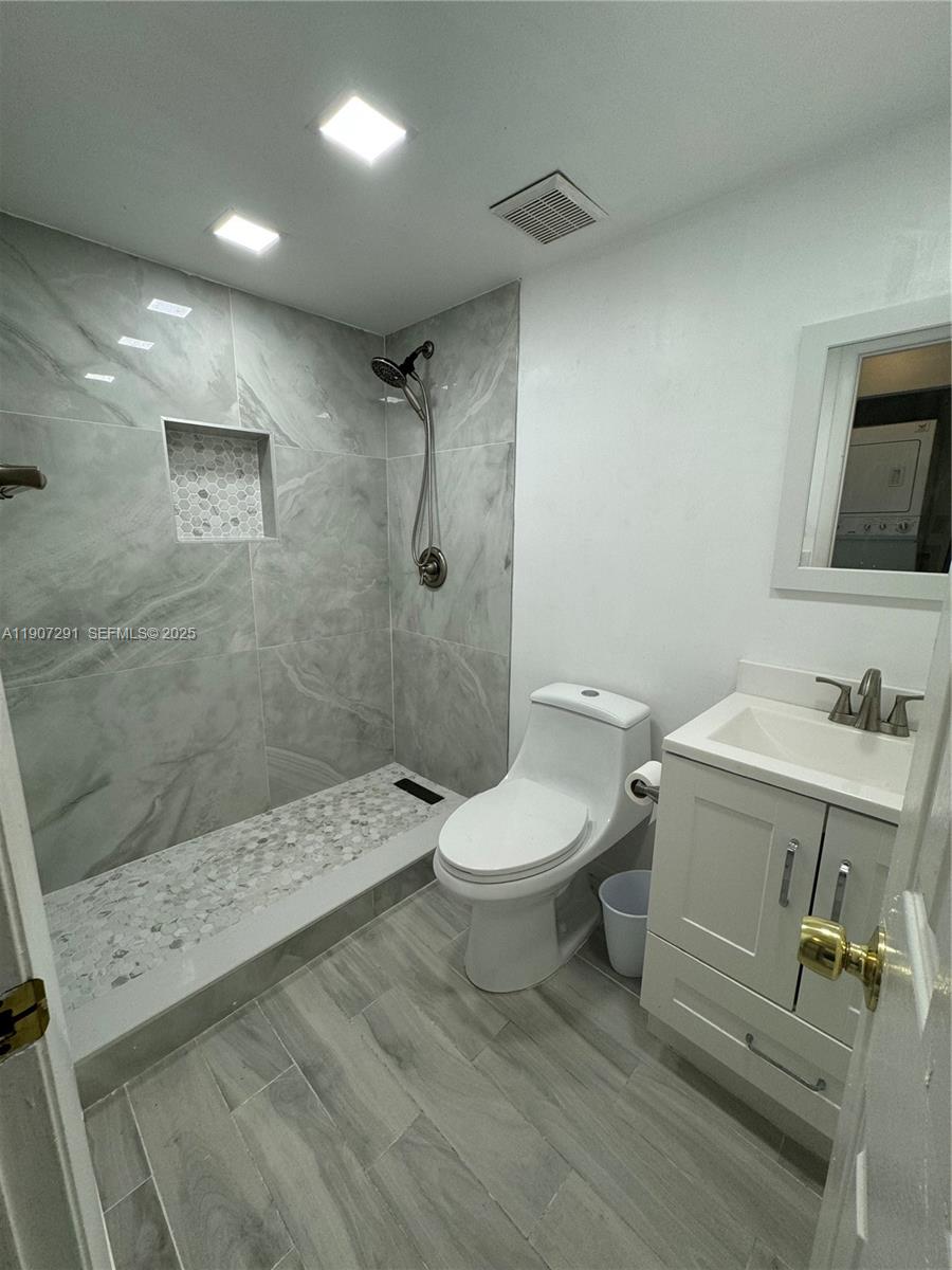 18250 Mediterranean Boulevard, Unit 1508 Hialeah, FL 33015 - Photo 17 of 26 a bathroom with a sink a toilet and shower