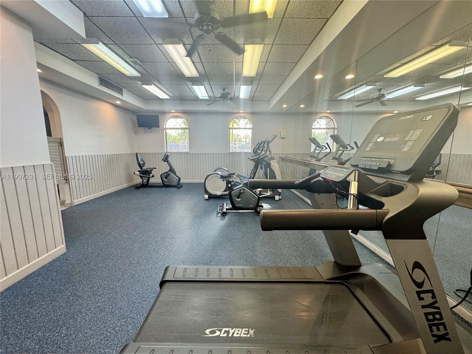 18250 Mediterranean Boulevard, Unit 1508 Hialeah, FL 33015 - Photo 24 of 26 a view of a room with gym equipment