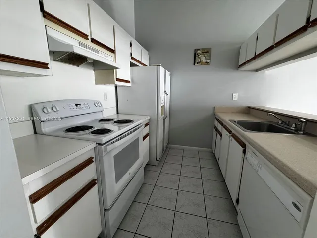 a kitchen with a stove and a refrigerator