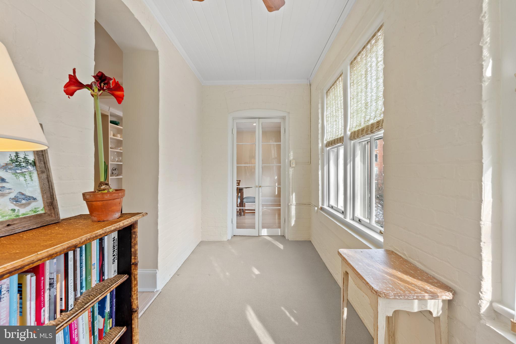 1657 31st Street Northwest, Unit 206 Washington, DC 20007 - Photo 9 of 26 a living room with furniture and a book shelf