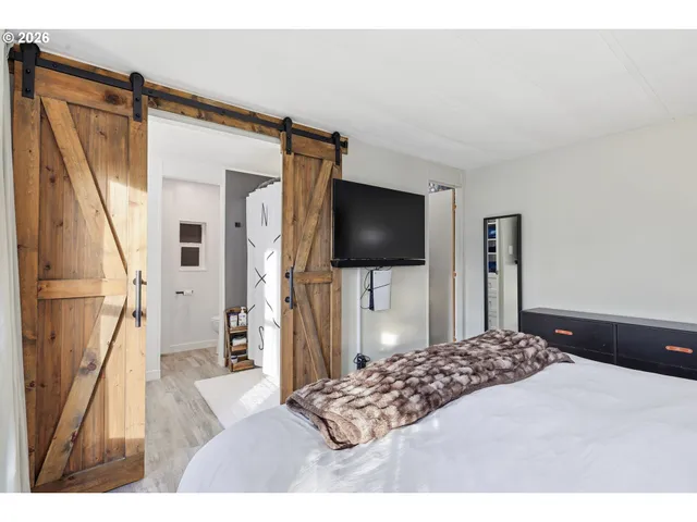 a bedroom with a bed and a flat screen tv