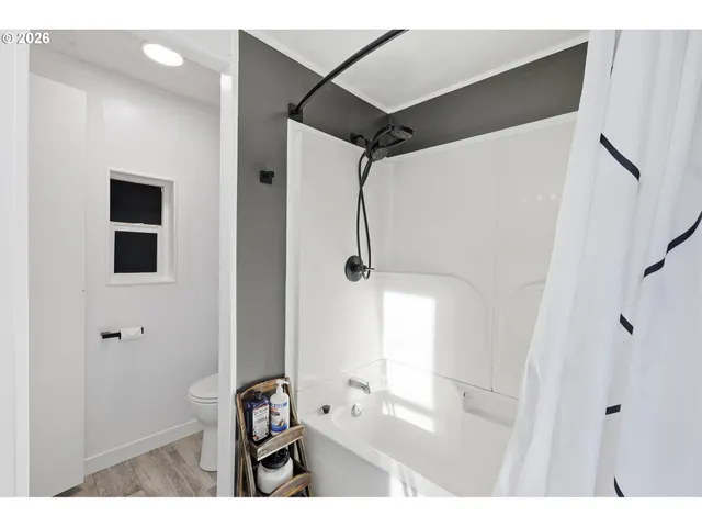 a bathroom with a bathtub and shower