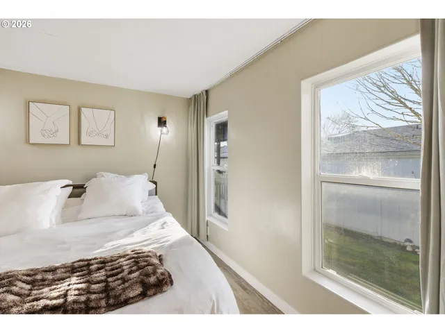 a bedroom with a large bed and a window