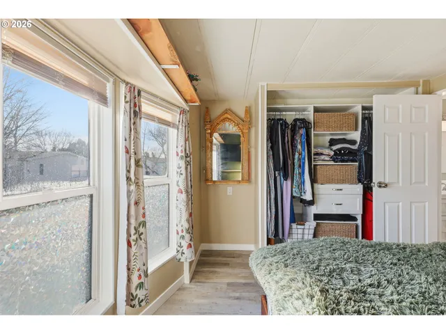 a bathroom with a granite countertop sink a mirror and a shower