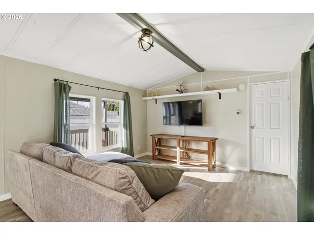 a bedroom with furniture and a flat screen tv