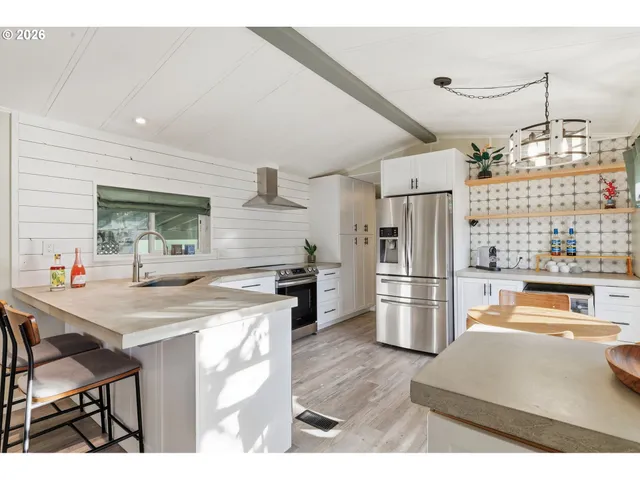 a kitchen with a refrigerator and a stove