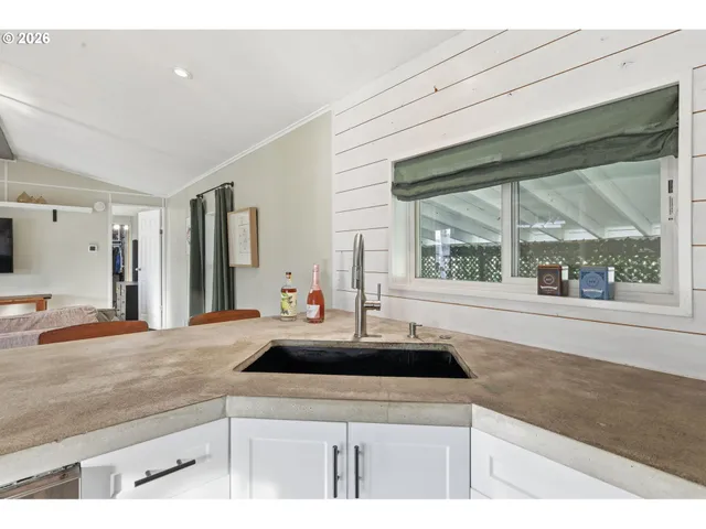 a kitchen with kitchen island a sink and a large window