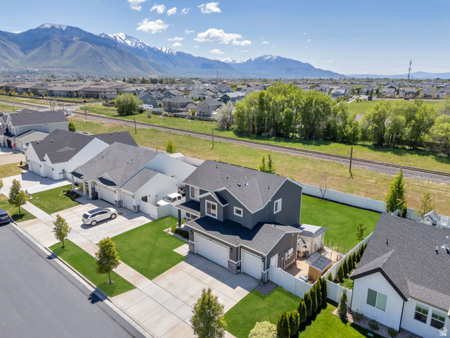 646 South Meade Street Mapleton, UT 84664 - Photo 28 of 46 Modern two-story residence featuring a dark gray exterior, attached two-car garage, and a fenced backyard with a patio area