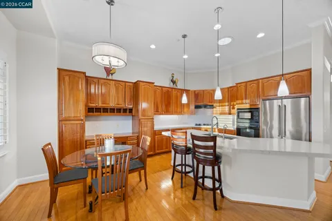 a view of a dining room with furniture wooden floor and chandelier