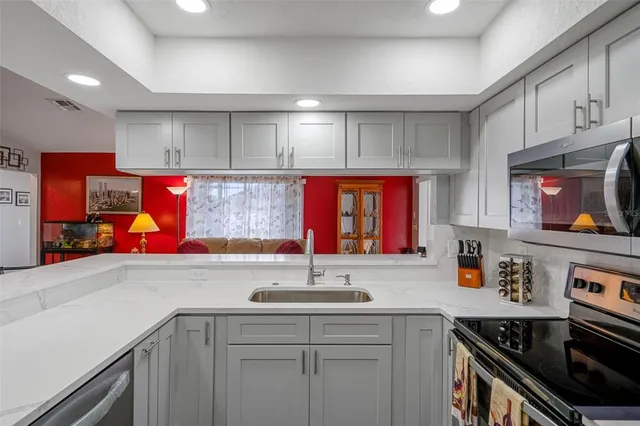 a kitchen with stainless steel appliances a refrigerator and a stove top oven