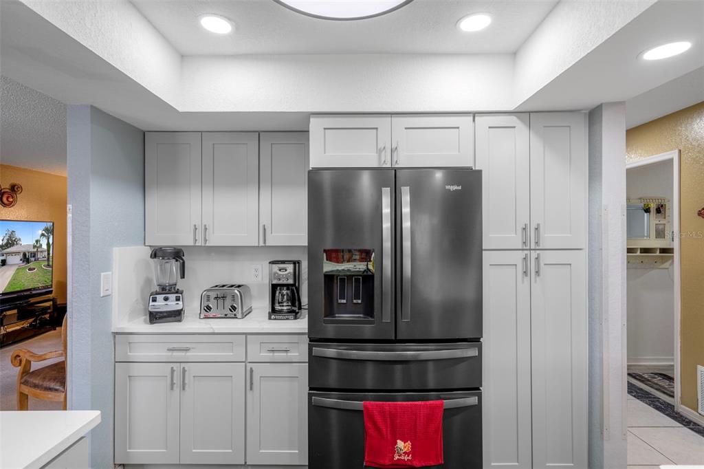 8158 Winding Oak Lane Spring Hill, FL 34606 - Photo 16 of 47 a kitchen with stainless steel appliances a refrigerator and a stove top oven