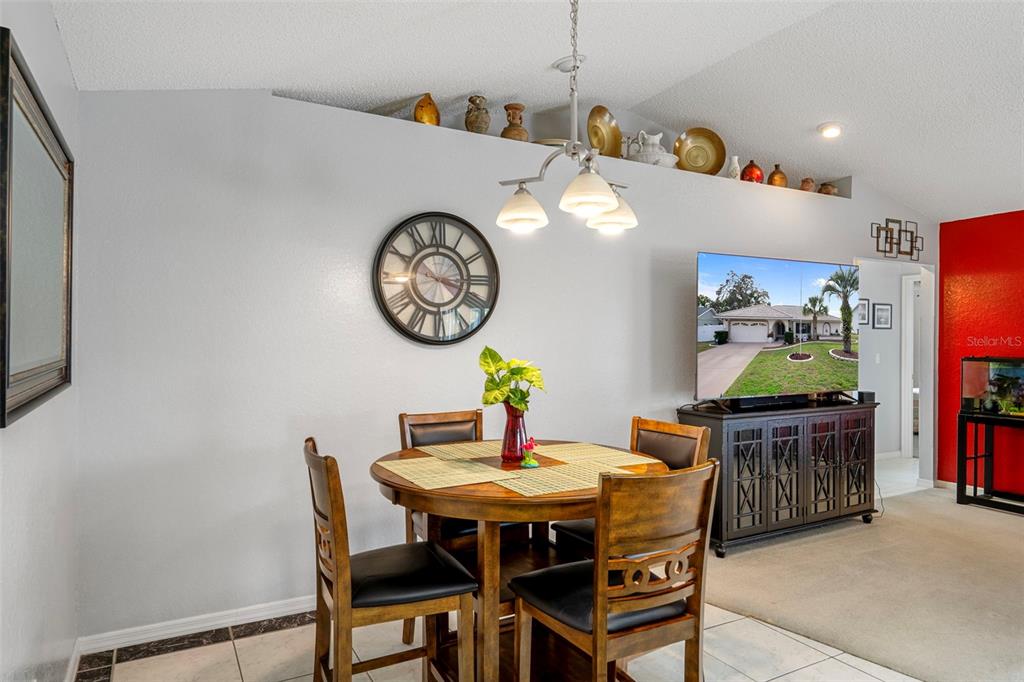 8158 Winding Oak Lane Spring Hill, FL 34606 - Photo 18 of 47 a view of a dining room with furniture and wooden floor