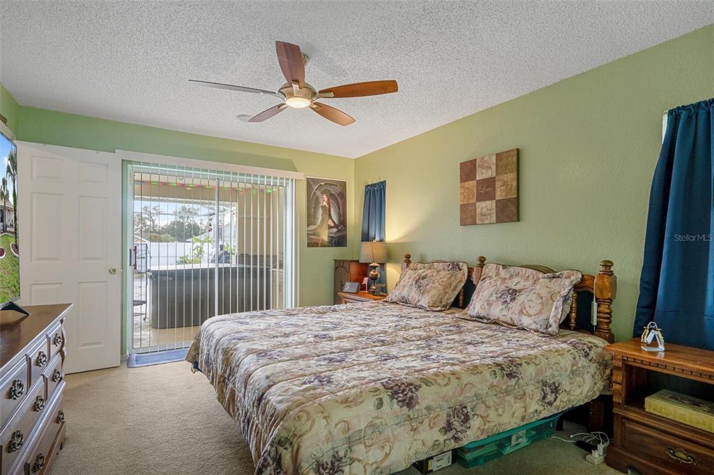 8158 Winding Oak Lane Spring Hill, FL 34606 - Photo 25 of 47 a bedroom with a bed and a window