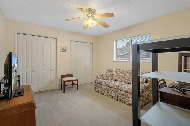 a bedroom with furniture and a flat screen tv