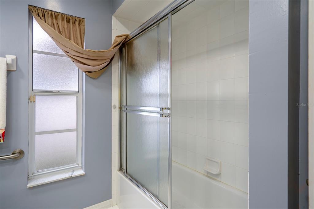 8158 Winding Oak Lane Spring Hill, FL 34606 - Photo 31 of 47 a bathroom with a mirror and a shower