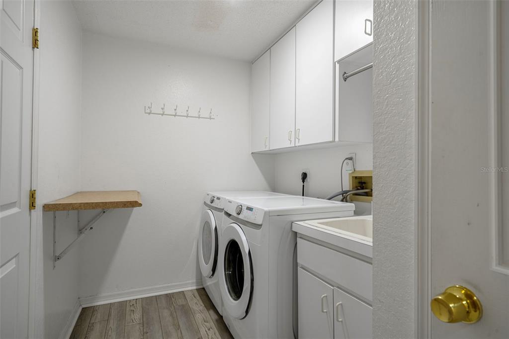 8158 Winding Oak Lane Spring Hill, FL 34606 - Photo 34 of 47 a utility room with dryer and washer