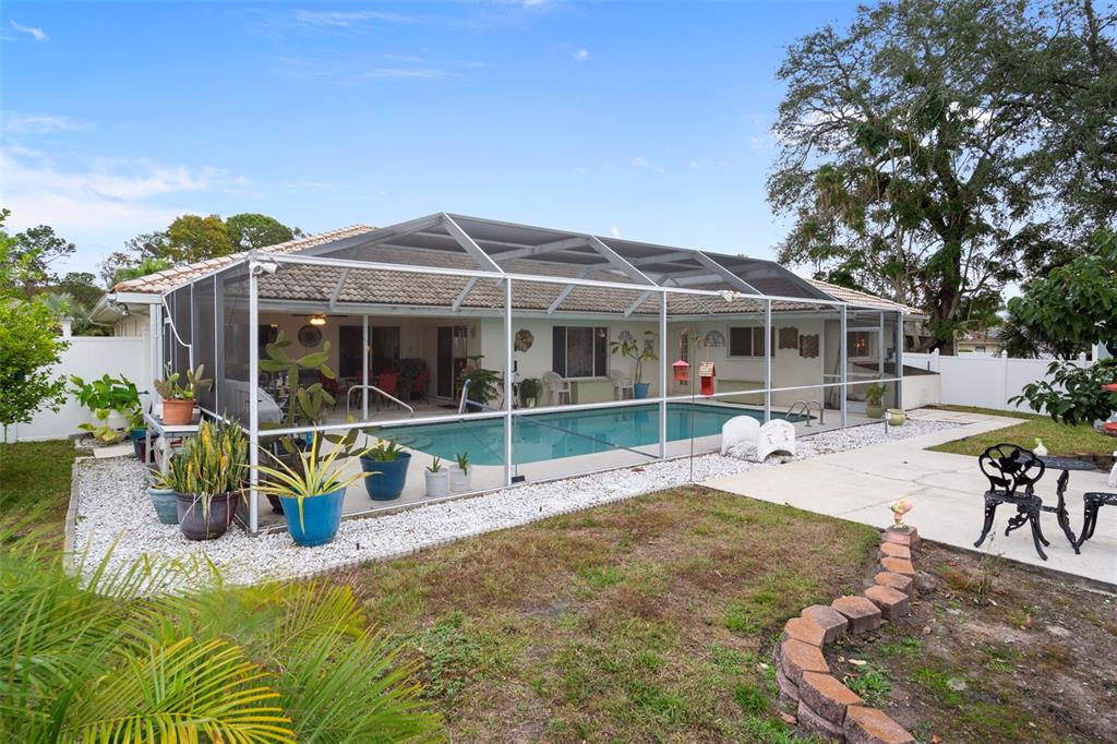 8158 Winding Oak Lane Spring Hill, FL 34606 - Photo 45 of 47 a view of a house with backyard porch and sitting area