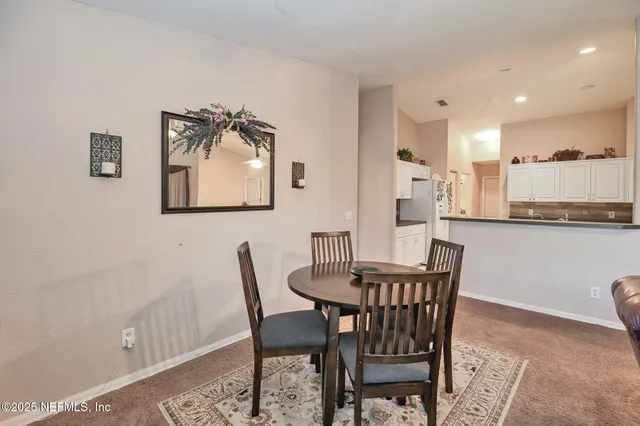 a dining room with furniture and window