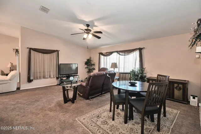 a view of a livingroom with furniture and a window