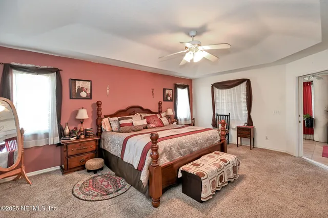 a bedroom with a bed and ceiling fan