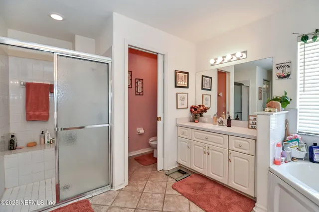 a spacious bathroom with a double vanity sink mirror and shower