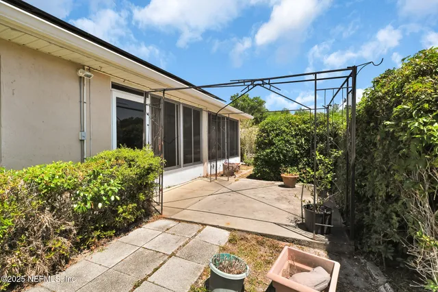 a view of a chair and table in the backyard of the house