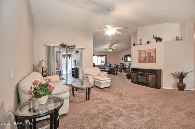 a living room with furniture and a kitchen