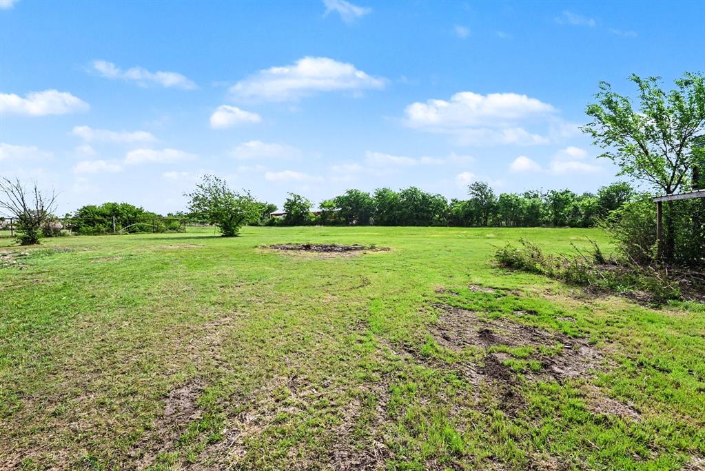 6694 Hutcheson Hill Road Springtown, TX 76082 - Photo 33 of 37 a view of a grassy field with trees